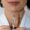 Woman pointing a needle to her lips