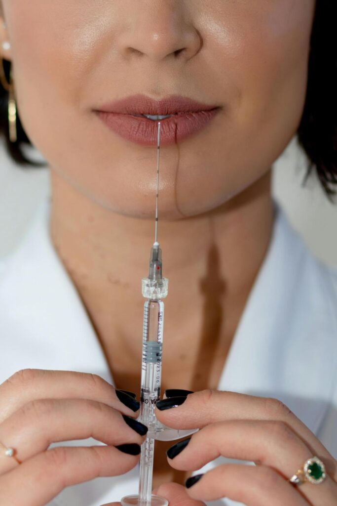 Woman pointing a needle to her lips